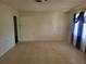 Bright and open living room featuring tile floors, large windows, and simple walls, a perfect place to unwind at 514 7Th S St, Dundee, FL 33838