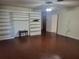 Spacious living room with hardwood floors, built-in shelving, and ample space, ideal for entertaining at 514 7Th S St, Dundee, FL 33838