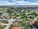 Scenic aerial view of a Gathering-friendly neighborhood, highlighting its idyllic setting near a tranquil lake at 5424 Moon Valley Dr, Lakeland, FL 33812