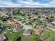 Residential aerial view showcasing the property's placement in a quiet neighborhood with tree-lined streets at 5424 Moon Valley Dr, Lakeland, FL 33812
