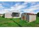 Backyard featuring a storage shed, green grass, and access to a screened patio on the house at 5424 Moon Valley Dr, Lakeland, FL 33812