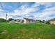 Spacious backyard featuring green lawn, shed, and screened-in porch, offering ample outdoor space at 5424 Moon Valley Dr, Lakeland, FL 33812