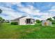 Spacious backyard features a shed, patio, green grass, and a white fence for privacy at 5424 Moon Valley Dr, Lakeland, FL 33812