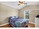 Bedroom with vaulted ceiling, ceiling fan, hardwood floors, and a window with natural light at 5424 Moon Valley Dr, Lakeland, FL 33812