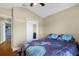 Bedroom featuring a vaulted ceiling, hardwood floors, and a closet with mirrored doors at 5424 Moon Valley Dr, Lakeland, FL 33812