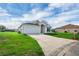 Exterior view of a home with well-maintained lawn, and a driveway leading to an attached garage at 5424 Moon Valley Dr, Lakeland, FL 33812