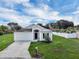 Charming single-story home features a well-manicured lawn and a two-car garage at 5424 Moon Valley Dr, Lakeland, FL 33812