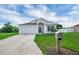 Inviting home exterior showcasing a concrete driveway and well-maintained landscaping at 5424 Moon Valley Dr, Lakeland, FL 33812