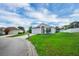 Exterior view of a home with well-maintained lawn, driveway, and a mailbox on the lawn at 5424 Moon Valley Dr, Lakeland, FL 33812