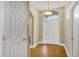Bright foyer with hardwood flooring and a large window above the front door at 5424 Moon Valley Dr, Lakeland, FL 33812