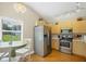 Bright kitchen with stainless steel appliances, light wood cabinets and a breakfast nook with backyard views at 5424 Moon Valley Dr, Lakeland, FL 33812