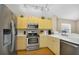 Well-lit kitchen featuring stainless steel appliances, light wood cabinetry, and ample counter space at 5424 Moon Valley Dr, Lakeland, FL 33812
