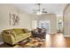 Comfortable living room with wood floors, ceiling fan, and access to the dining area at 5424 Moon Valley Dr, Lakeland, FL 33812