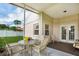 Enclosed back patio with outdoor seating and views of the lawn and a white vinyl fence at 5424 Moon Valley Dr, Lakeland, FL 33812