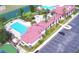 An aerial view of the community pool and clubhouse featuring ample parking and lake views at 545 Pond Cypress Ct, Auburndale, FL 33823