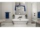 Bright bathroom with a freestanding tub, marble tile shower, and double vanities at 545 Pond Cypress Ct, Auburndale, FL 33823