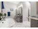 Bathroom with a freestanding tub, gray cabinets, granite counters and modern fixtures at 545 Pond Cypress Ct, Auburndale, FL 33823