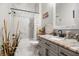 Stylish bathroom with a marble-tiled shower, neutral-toned vanity, and contemporary fixtures at 545 Pond Cypress Ct, Auburndale, FL 33823