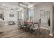 Elegant dining room featuring a modern chandelier, sleek table with silver accents, and stylish decor at 545 Pond Cypress Ct, Auburndale, FL 33823