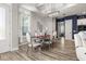 Elegant dining room with a modern chandelier, hardwood floors, and stylish furnishings at 545 Pond Cypress Ct, Auburndale, FL 33823