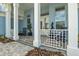 Charming front porch with white railings, rocking chairs, and elegant landscaping at 545 Pond Cypress Ct, Auburndale, FL 33823