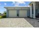 Spacious two-car garage with a wide brick driveway and well-maintained landscaping at 545 Pond Cypress Ct, Auburndale, FL 33823
