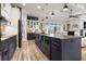 Spacious kitchen with a black island, stainless steel appliances, and an open view to the living area at 545 Pond Cypress Ct, Auburndale, FL 33823