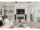 Cozy living room with a modern fireplace, hardwood floors, and stylish decor at 545 Pond Cypress Ct, Auburndale, FL 33823