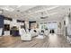 Spacious open-concept living area with hardwood floors, modern lighting, and stylish furnishings at 545 Pond Cypress Ct, Auburndale, FL 33823