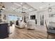 Open-concept living room featuring a decorative ceiling, modern lighting, and hardwood flooring at 545 Pond Cypress Ct, Auburndale, FL 33823