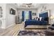 Elegant main bedroom showcasing a plush bed, modern dresser, and well-lit windows at 545 Pond Cypress Ct, Auburndale, FL 33823