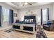 Luxurious main bedroom featuring a plush blue bed, accent lighting, and large windows at 545 Pond Cypress Ct, Auburndale, FL 33823