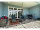 Covered patio with comfortable seating, a ceiling fan and a view of the backyard at 545 Pond Cypress Ct, Auburndale, FL 33823