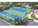 Aerial view of the community tennis and pickle ball courts that are surrounded by lush landscaping at 545 Pond Cypress Ct, Auburndale, FL 33823