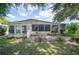 Backyard featuring a patio, lush lawn, and mature landscaping at 6027 Grand Oaks Se Dr, Winter Haven, FL 33884