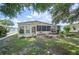 Backyard featuring a patio, lush lawn, and mature landscaping at 6027 Grand Oaks Se Dr, Winter Haven, FL 33884