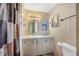 Bathroom features a single vanity, small window and a toilet at 6027 Grand Oaks Se Dr, Winter Haven, FL 33884