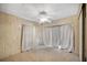 Bright bedroom with ceiling fan and ample natural light through large windows at 6027 Grand Oaks Se Dr, Winter Haven, FL 33884