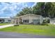 Charming single-story home with a well-manicured lawn, complemented by mature trees and a convenient carport at 6027 Grand Oaks Se Dr, Winter Haven, FL 33884