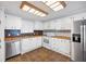 Well-equipped kitchen with white cabinetry, modern appliances, and tile flooring for easy maintenance at 6027 Grand Oaks Se Dr, Winter Haven, FL 33884