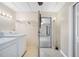 Bright laundry room with shelving, washer, and access to other rooms at 6027 Grand Oaks Se Dr, Winter Haven, FL 33884