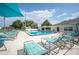 Community pool with sun loungers, umbrellas, and a clubhouse at 6027 Grand Oaks Se Dr, Winter Haven, FL 33884