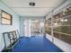 Enclosed porch with blue carpet, white walls, and natural light at 6027 Grand Oaks Se Dr, Winter Haven, FL 33884