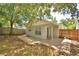 House backyard with mature trees and patio area, perfect for outdoor relaxing at 658 Lake Dexter Cir, Winter Haven, FL 33884