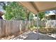 Enclosed backyard with mature trees and patio area, perfect for outdoor entertaining at 658 Lake Dexter Cir, Winter Haven, FL 33884