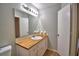The bathroom features a sink, butcher block countertops, framed mirror and wood-look floors at 658 Lake Dexter Cir, Winter Haven, FL 33884