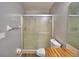 Bathroom includes walk-in shower, toilet, butcher block vanity and brushed nickel fixtures at 658 Lake Dexter Cir, Winter Haven, FL 33884