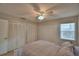 Bedroom offering a ceiling fan, closet, window for natural light, and neutral tones at 658 Lake Dexter Cir, Winter Haven, FL 33884