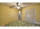 Cozy bedroom features a ceiling fan, neutral color, and double closet at 658 Lake Dexter Cir, Winter Haven, FL 33884