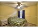Bedroom features a ceiling fan, carpet, window, and single bed at 658 Lake Dexter Cir, Winter Haven, FL 33884